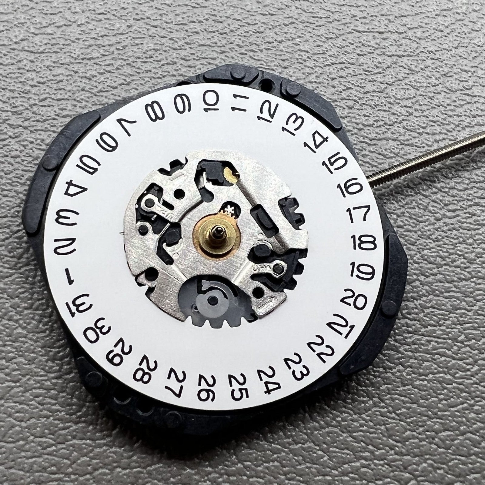 1. Japan Hattori Epson VX32 quartz watch movement with date at 3 o'clock, precise timekeeping.
