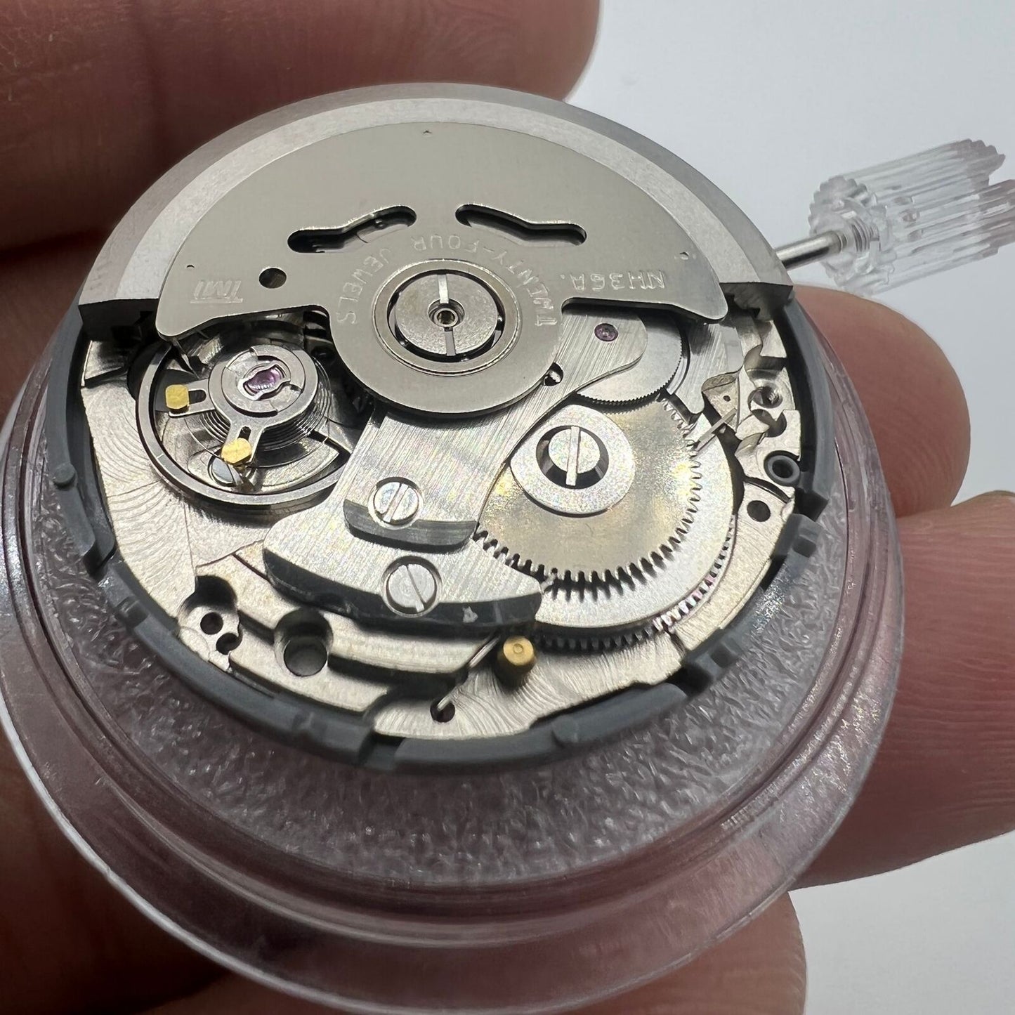 Black NH36A automatic watch movement with Roman wheel and crown at 3 o'clock.