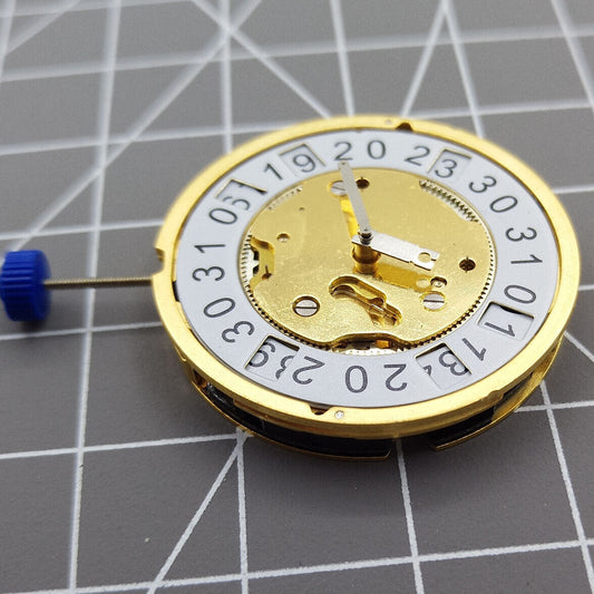 Golden Swiss Made Ronda 5040B quartz watch movement for precise timekeeping in luxury accessories.