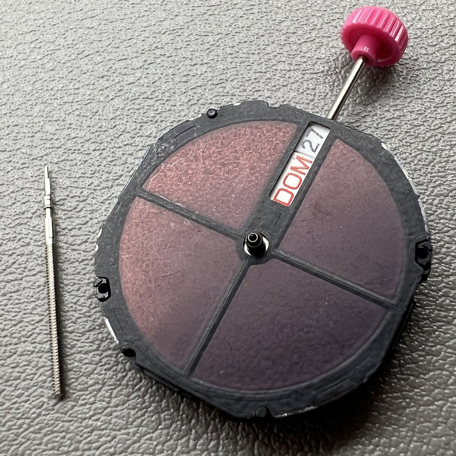 Citizen Eco-Drive E100 solar watch featuring quartz movement and day-date display on a sleek black dial.