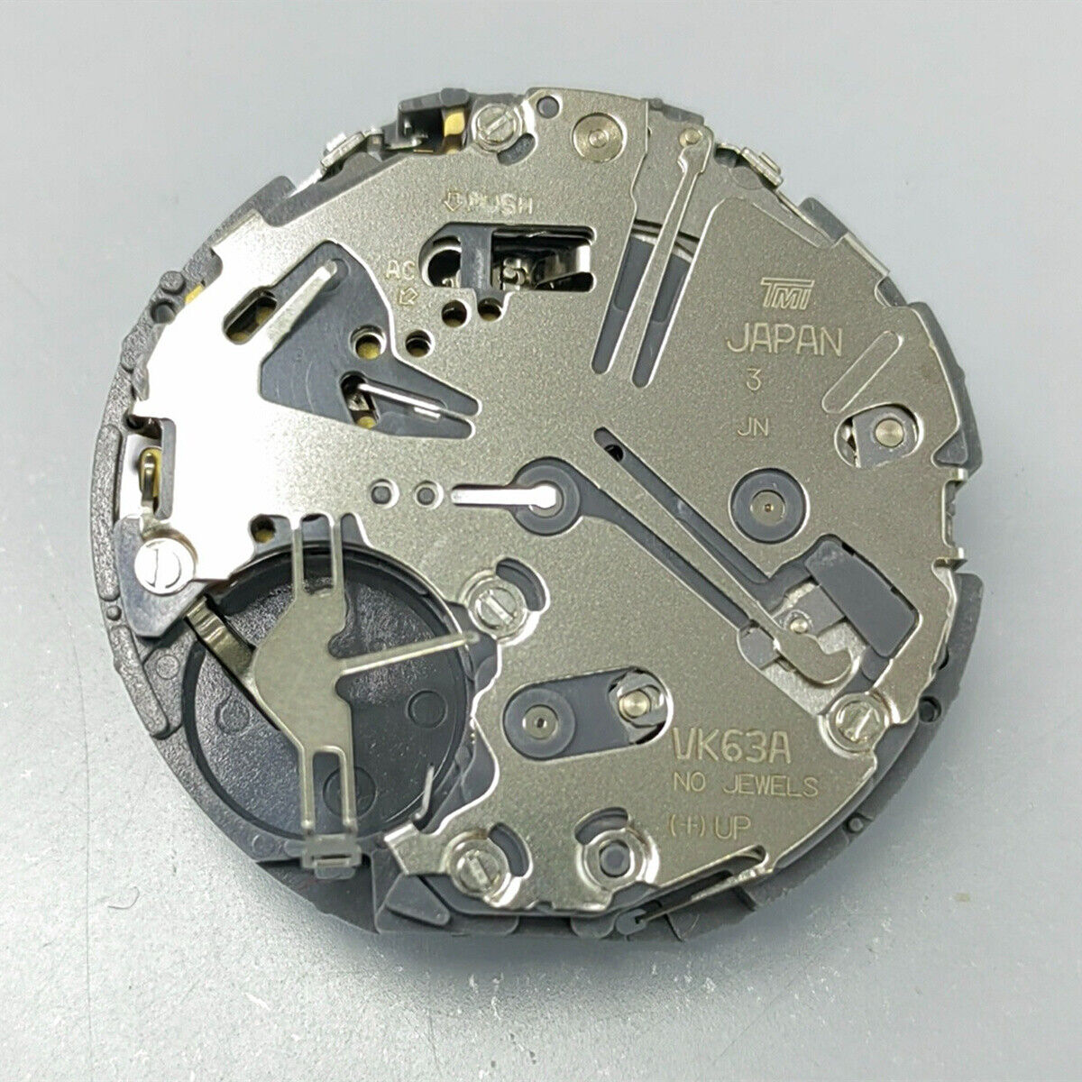 Black disk watch part with Seiko VK63 quartz movement, Japan made, for precise timepiece repair.