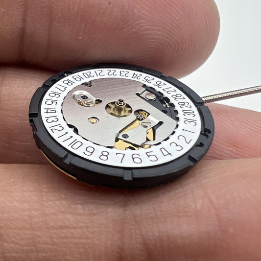 ISA 338 quartz watch movement with date at 6, 3 hands, ideal for repair parts and replacements.