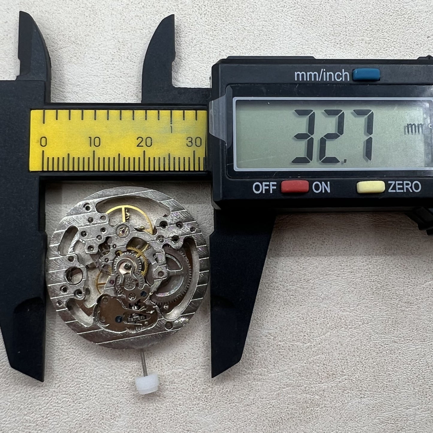 Hollow silver manual winding watch movement displaying detailed mechanical craftsmanship.
