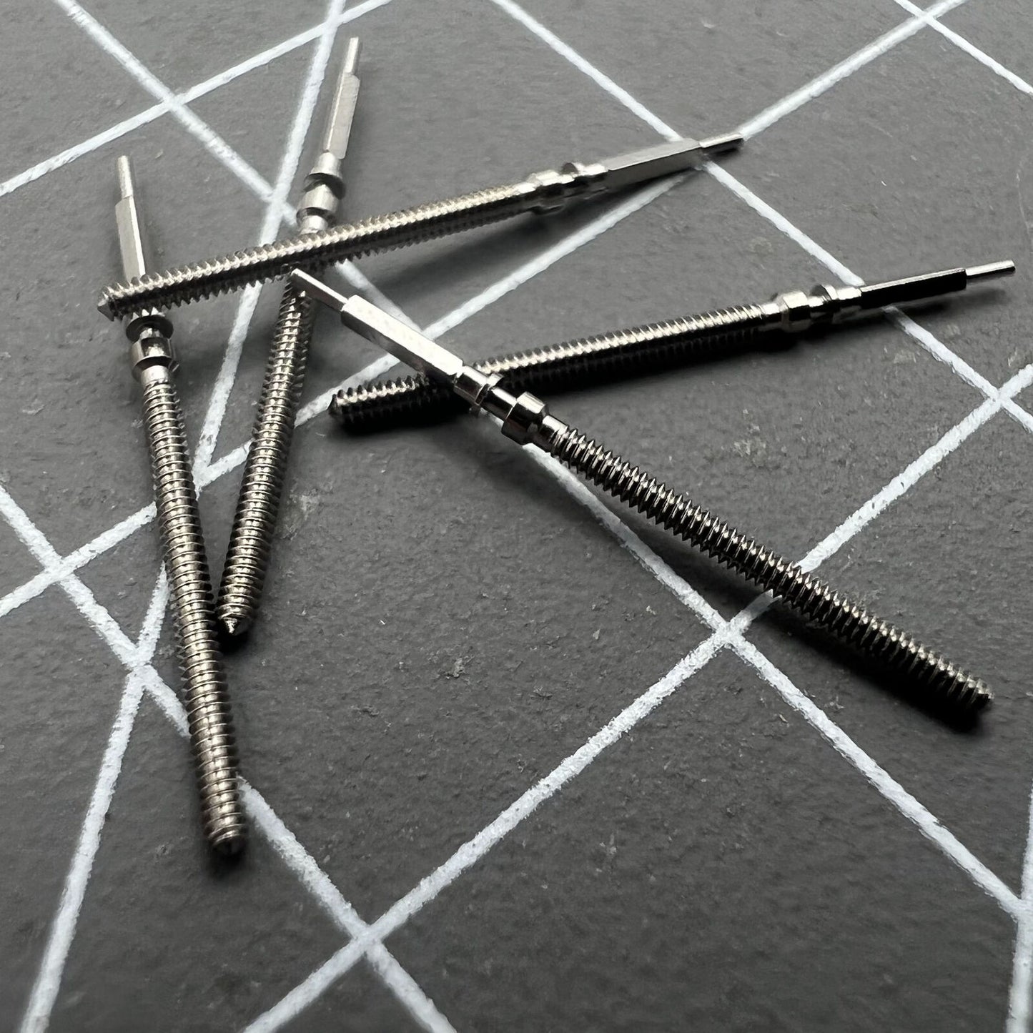 Precision watch winding stem for Omega 560 series movements, high-quality spare part for repairs.