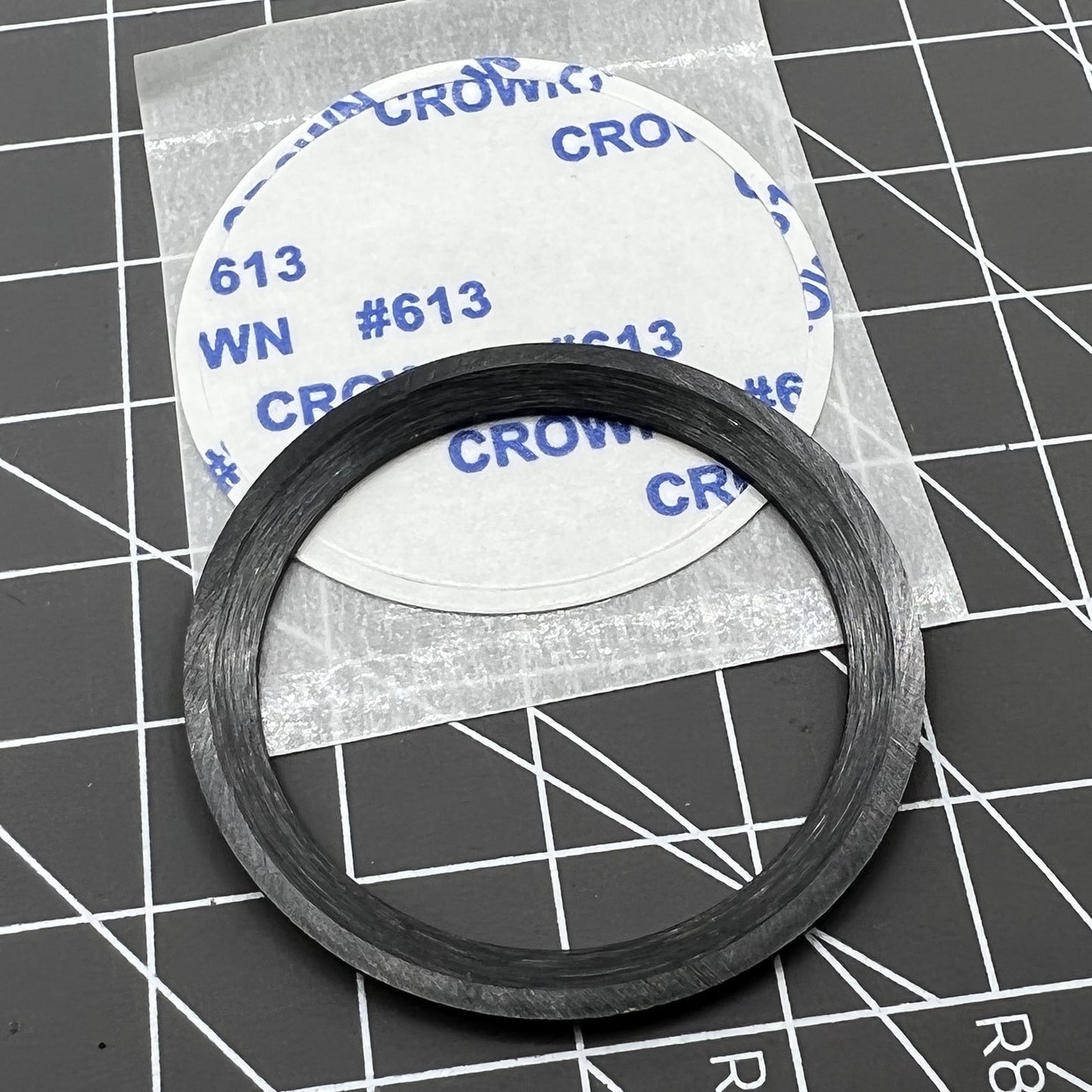 38mm black ceramic bezel insert with orange markers, durable and precise for watch time tracking.
