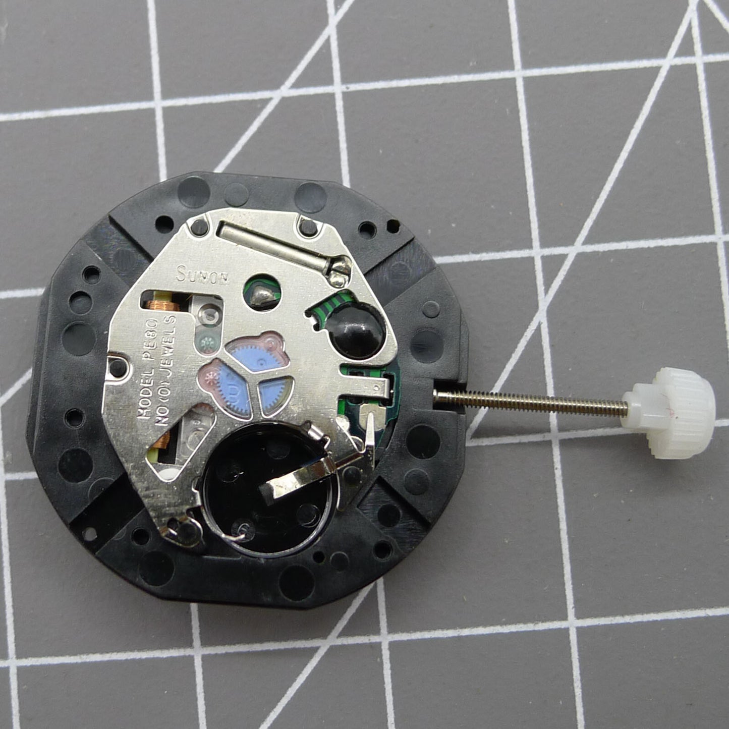 Sunon PE80 quartz watch movement featuring three hands and small seconds at 3, 6, and 9 o'clock positions for precision timekeeping.