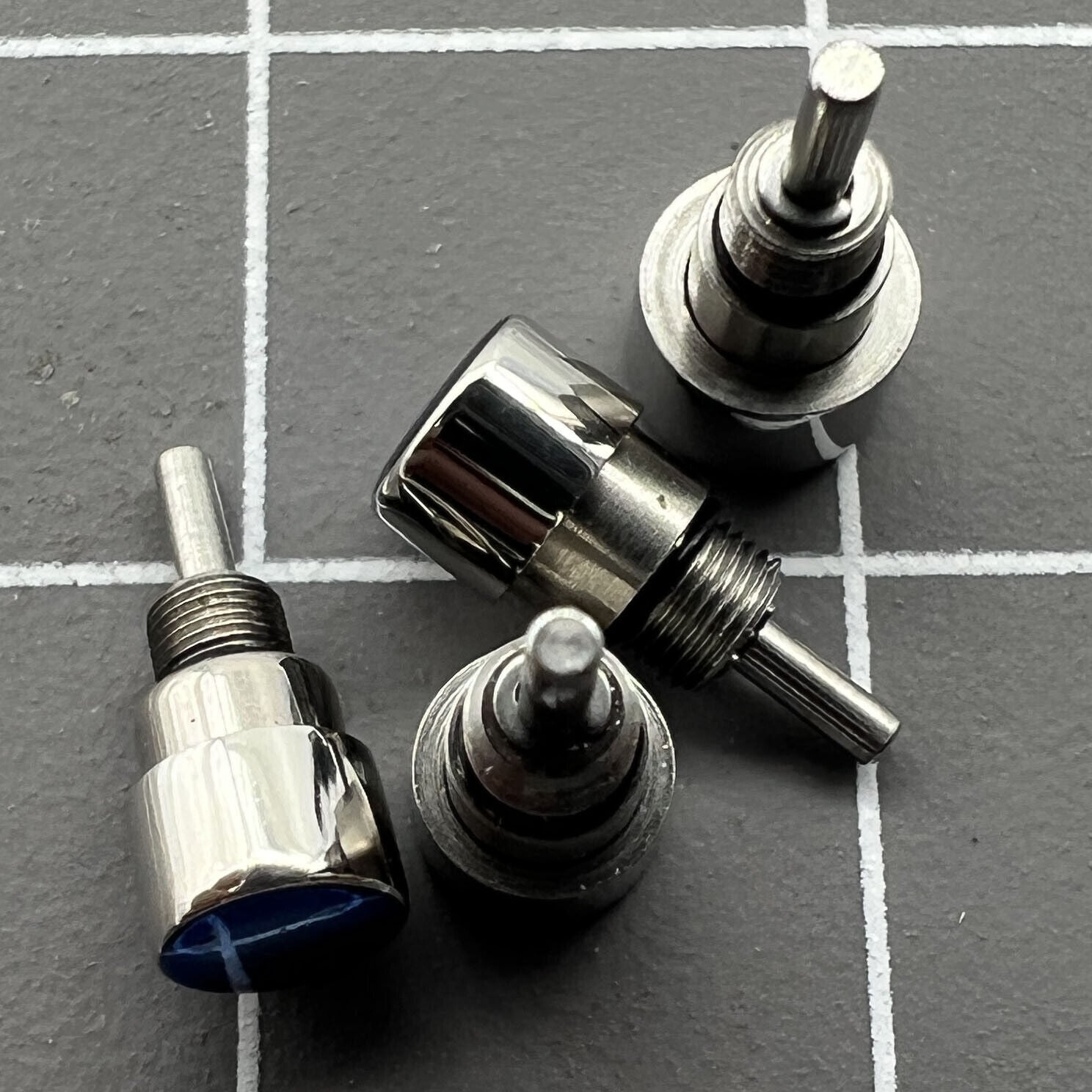 Silver stainless steel watch accessory set, 14 pieces in 7 sizes for classic pusher drive mechanisms.