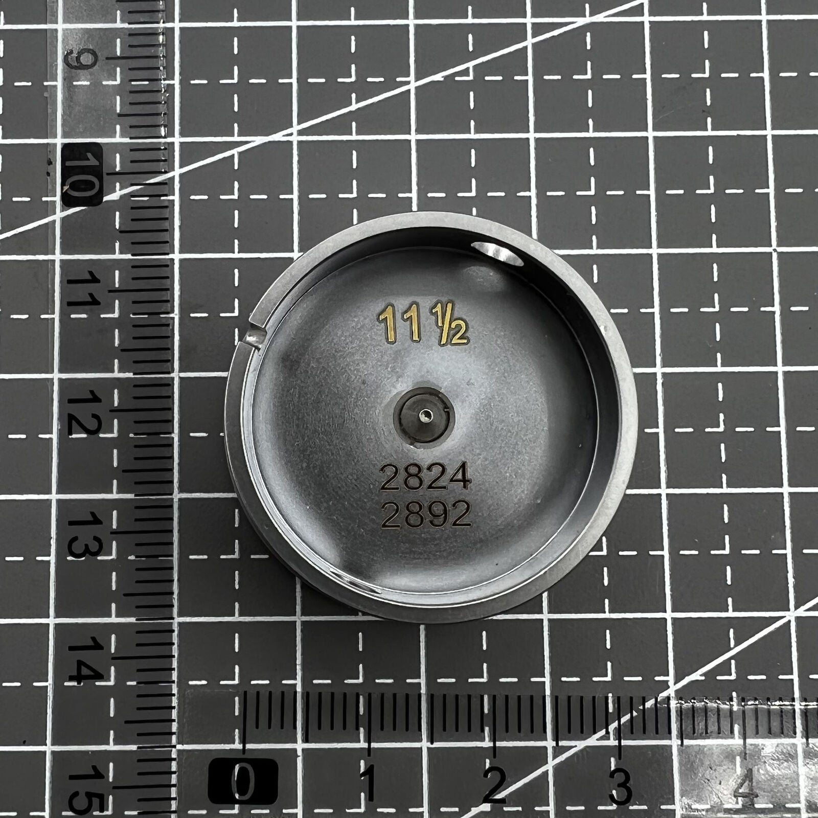 Watch movement holder for ETA 2892/2824, secure center screw design, essential watch repair tool.