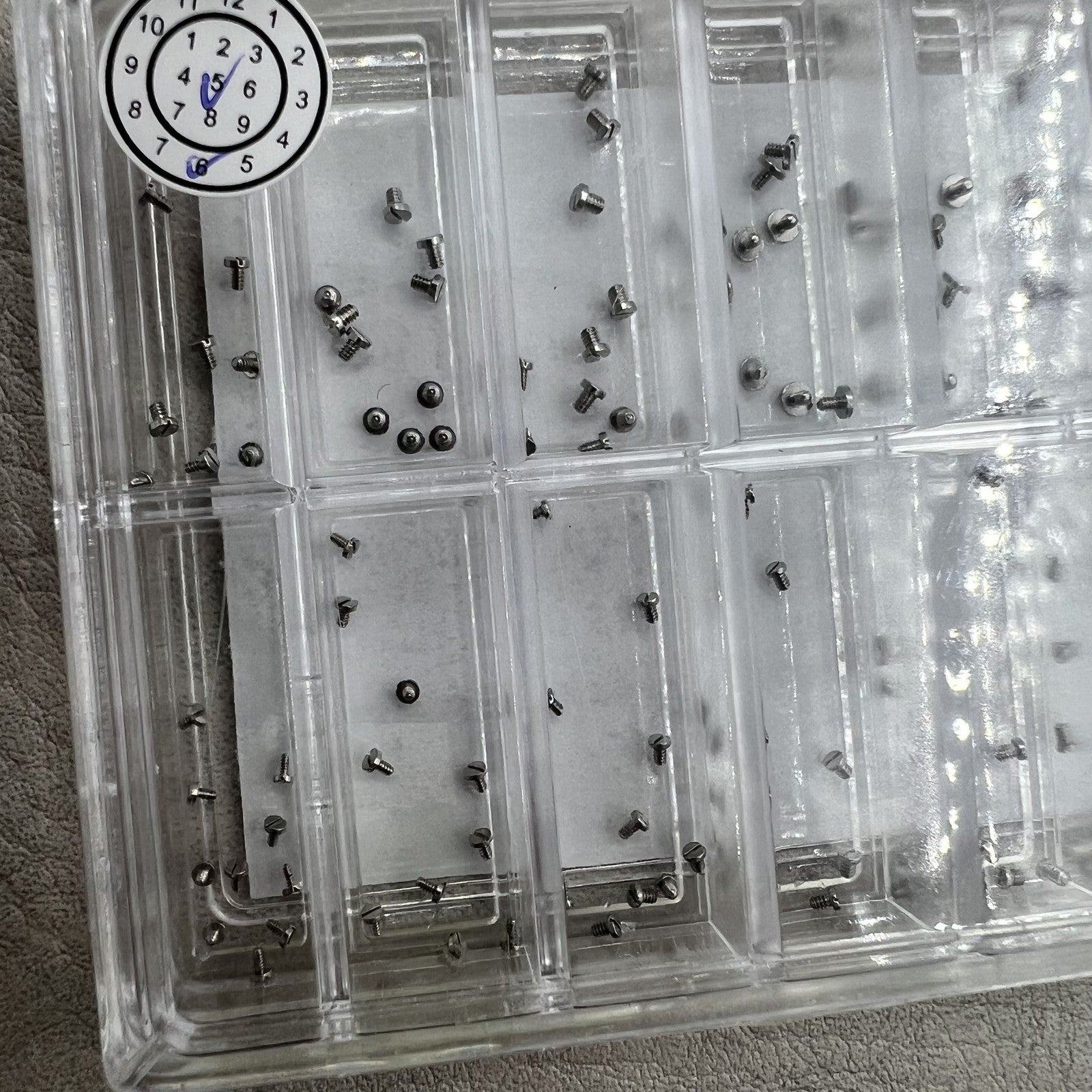 Set of 180 high-end stainless steel mini screws with straight line head for watch case backs.