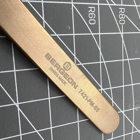 SWISS MADE Bergeon 7421-PM-S5 bronze tweezers for precise watch accessory handling.