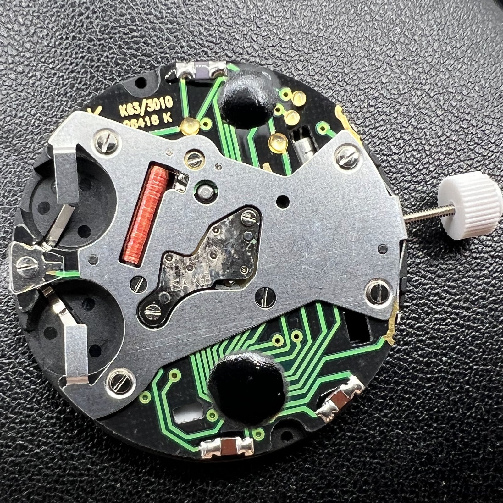 ISA K63 Swiss quartz watch movement showing three-hand display with dual battery power for accurate timing.