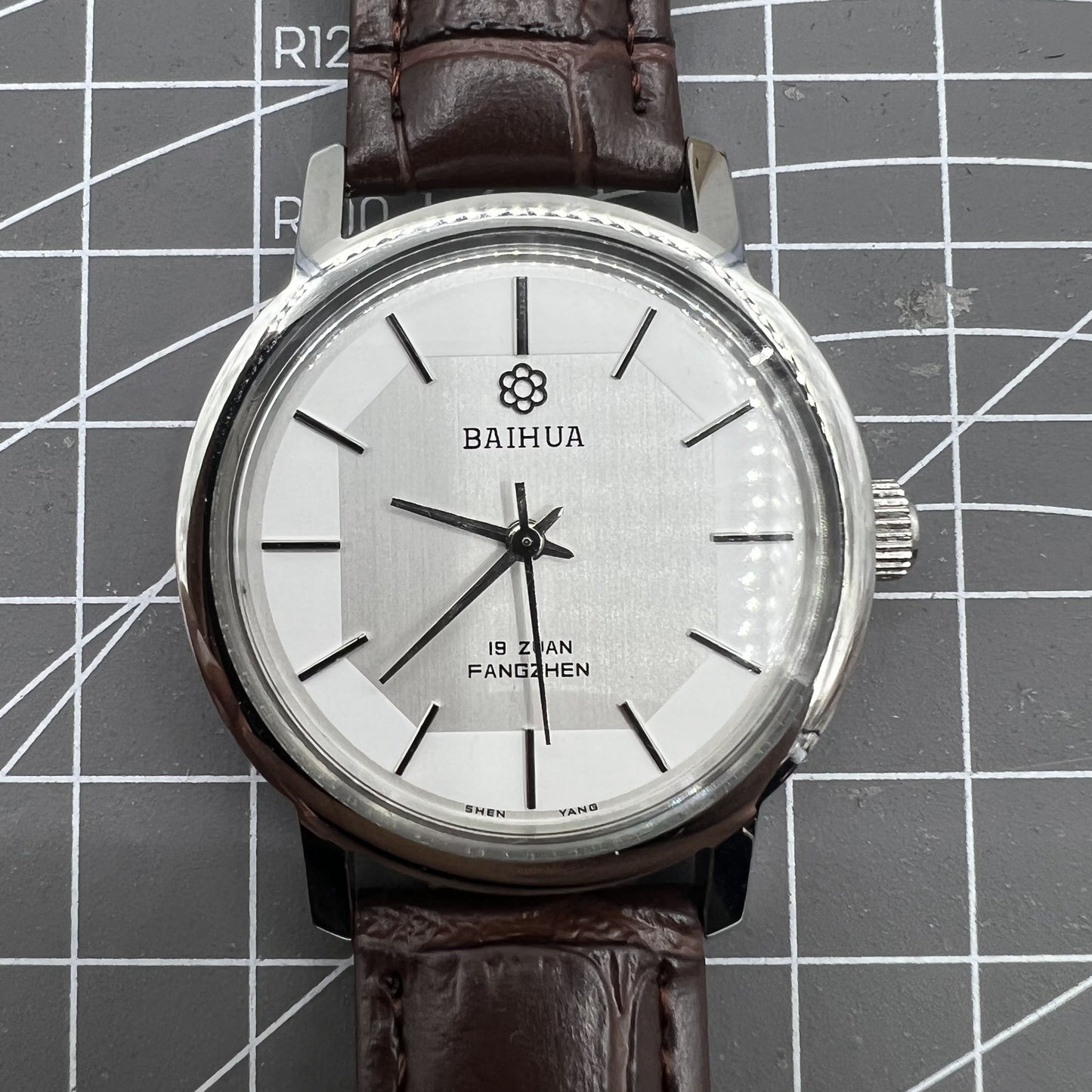 China Baihua 37mm manual mechanical watch with silver dial, 19 jewels, and shock-resistant design for durable precision.