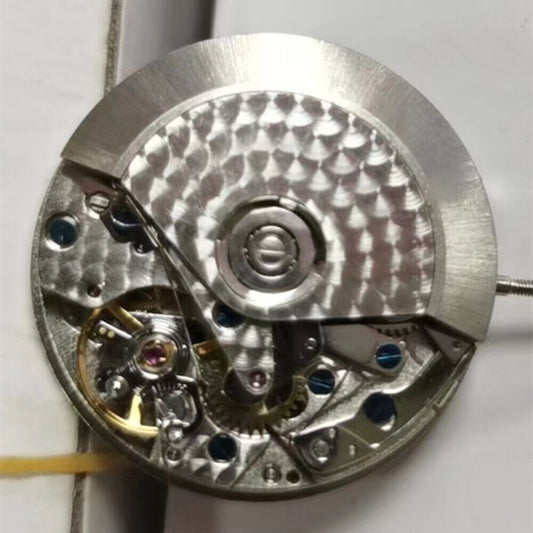 Dandong 7750 chronograph watch movement showing small seconds at 3, 6, 9 and date at 12 marks.