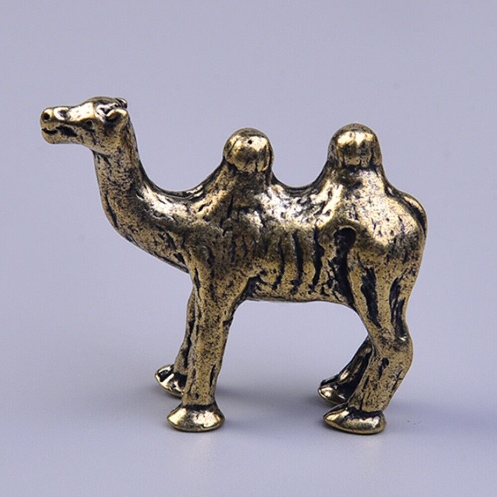Hand-carved solid copper camel trinket, vintage bronze-toned collectible figurine.