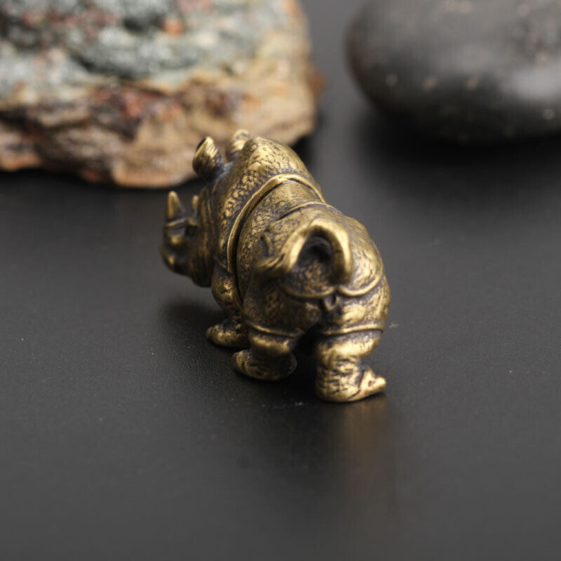Hand-carved vintage bronze rhinoceros figurine by Solid Copper for elegant watch accessory display.