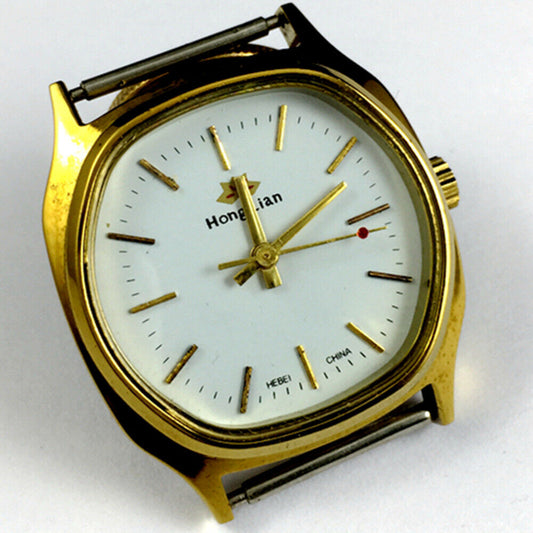 HONGLIAN 33mm manual mechanical watch with white dial, gold nail markers, and square gold case.
