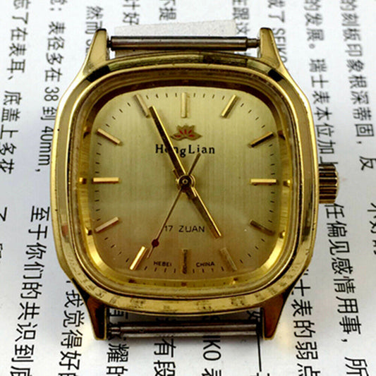HONGLIAN manual mechanical watch with golden nail markers, square golden case, and elegant golden dial.