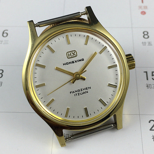 33mm Chinese manual mechanical watch with golden nails, silver dial, and round golden case.