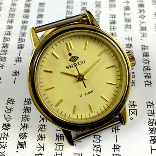 34mm China made manual mechanical watch with 17 jewels, golden dial, and round golden case.