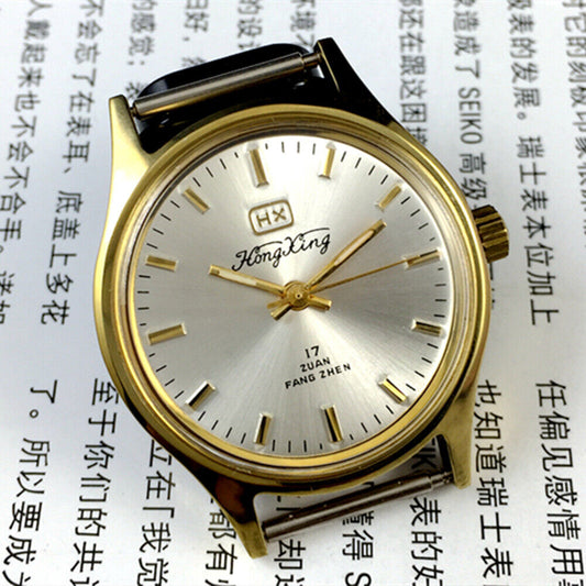 33mm China Made manual mechanical watch with golden nail markers and silver dial, shock-resistant design.