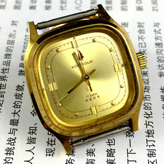 Dandong 33mm manual mechanical watch with 17 jewels, golden dial, and square case in luxury style.