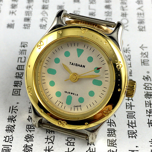 Elegant 28mm TAISHAN lady watch with golden case, numeric markers, manual mechanical movement, and 19 jewels.