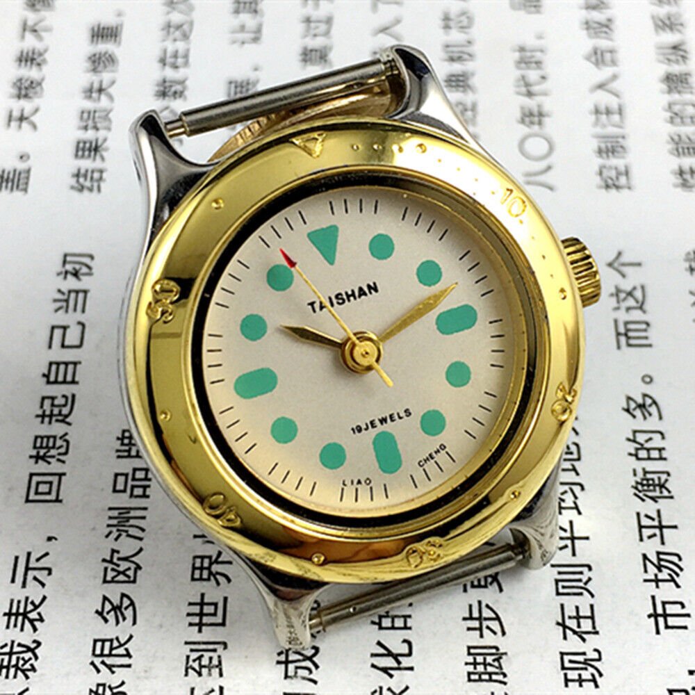 TAISHAN 28mm elegant ladies watch with golden case, numeric markers, manual mechanical movement, and 19 jewels.