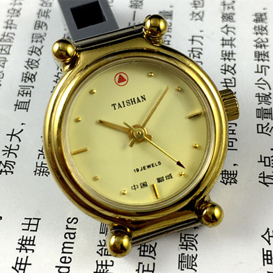 TAISHAN 27mm manual mechanical lady watch with golden case and yellow dial, 19 jewels for precision.