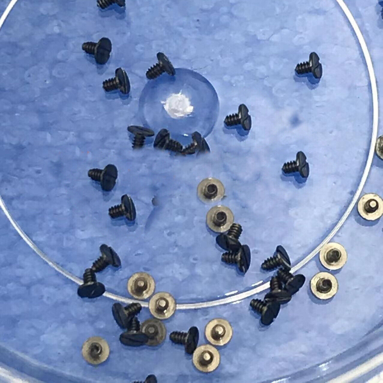 Generic SA100 watch screws securing Second/Mainspring Wheel Bridge Splint for precise movement assembly.