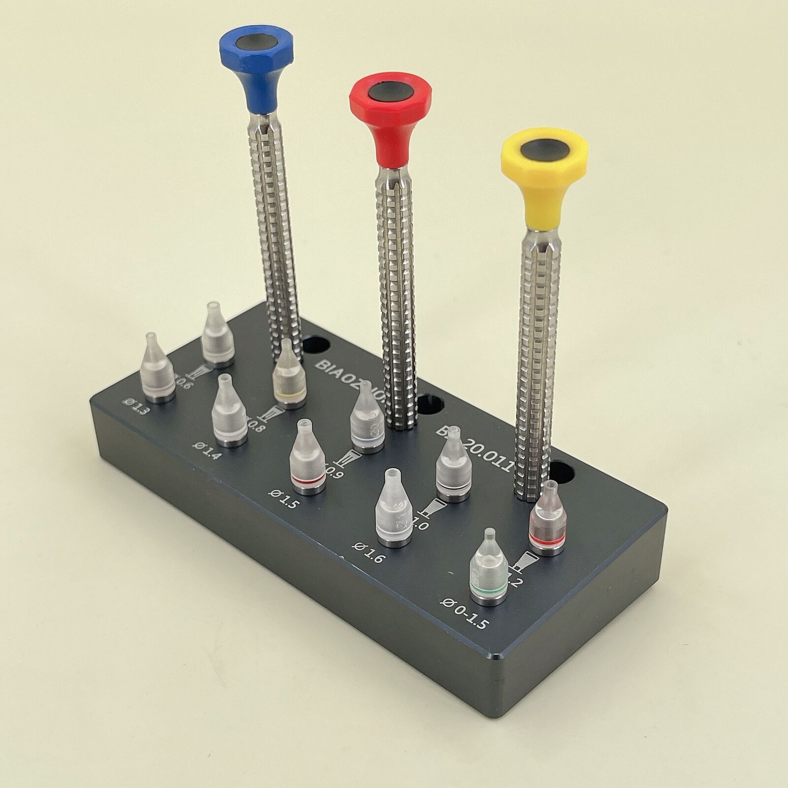 1. Set of 10 watch hand fitting tools with base for precise watch repair.