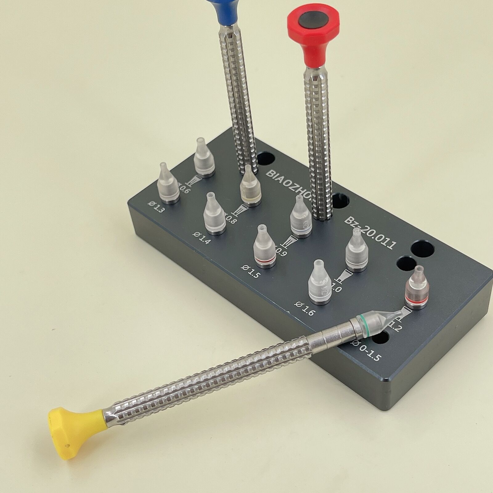 Set of 10 precise watch hand fitting tools with base for accurate watch repair.