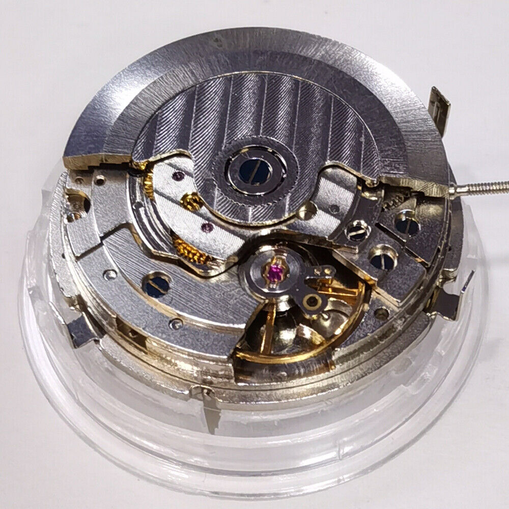 Automatic mechanical watch with silver dial, week/month display at 12, and moon phase at 6.