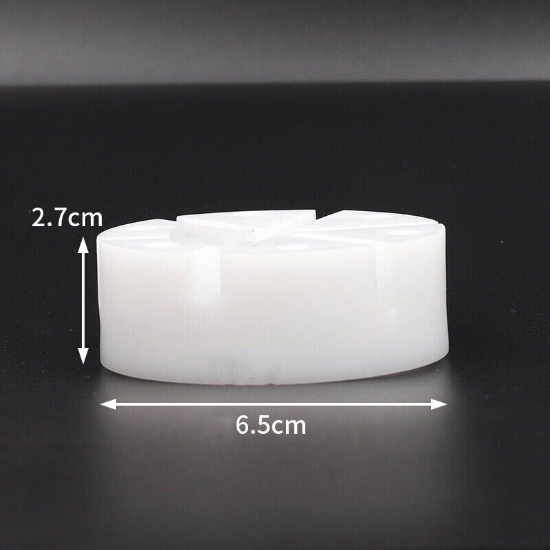 White watch band holder block with pins remover tool for watch strap repair and adjustment.