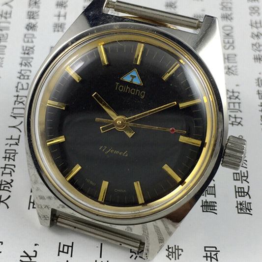 Black dial 32mm Taihang manual mechanical watch with golden nails, 17 jewels for precise timekeeping.