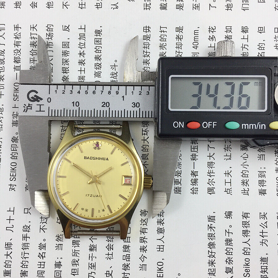 Yellow dial 33mm manual watch with single calendar, 17 jewels, shock-resistant for elegant timekeeping.