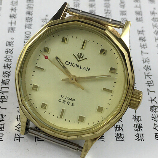 32mm China-made manual mechanical watch with 17 jewels, yellow dial, and green lume hands.