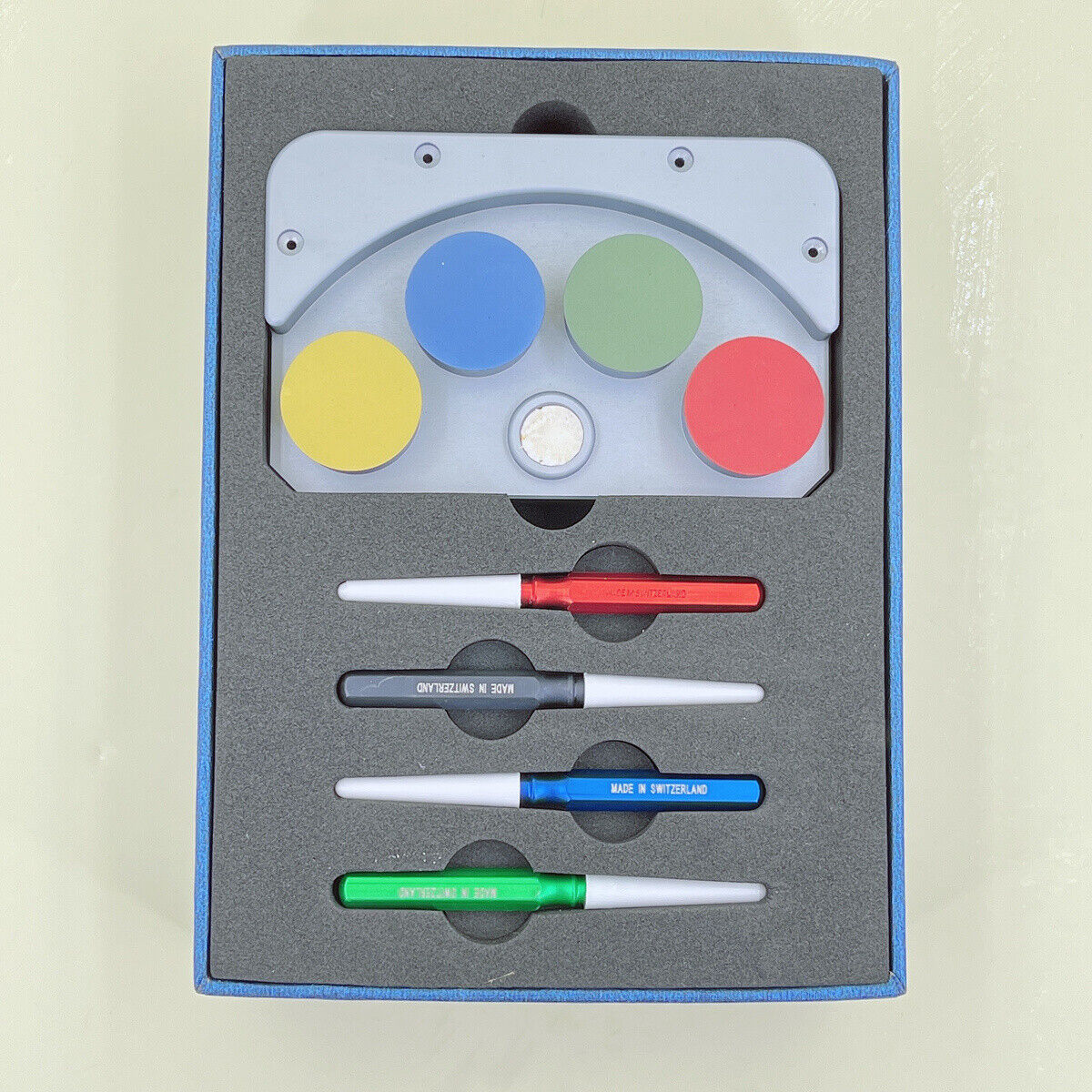 Die-cast alloy MSA17.000-04 oil cup stand with 4 containers for precise watch repair.