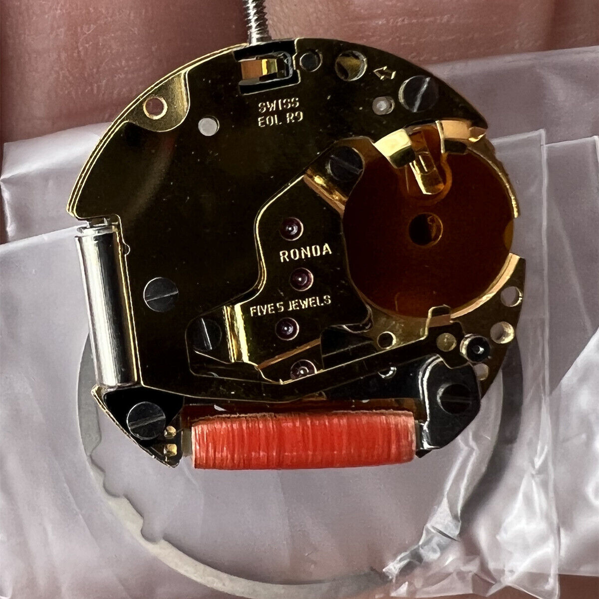 Ronda 775 Swiss Made golden quartz watch movement featuring date display at 6 o'clock for precise timekeeping