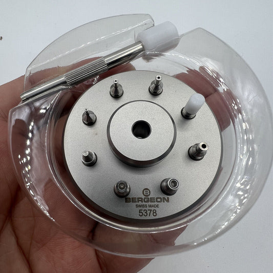 Bergeon 5378 Swiss watch hand fitting tool with 9 stakes on holder for precise assembly.