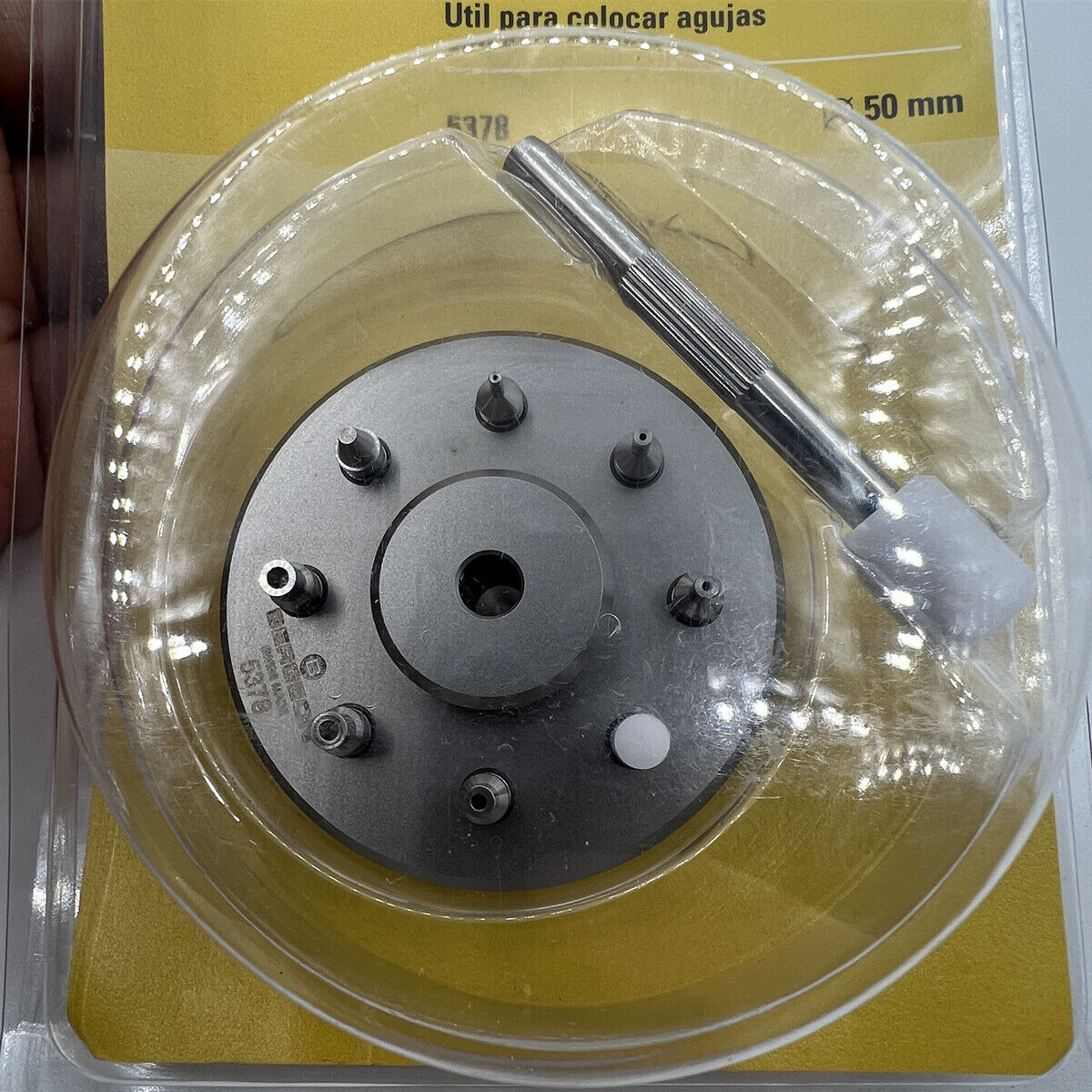 Bergeon 5378 Swiss watch hand fitting tool with 9 stakes on holder for precise watch repair assembly.