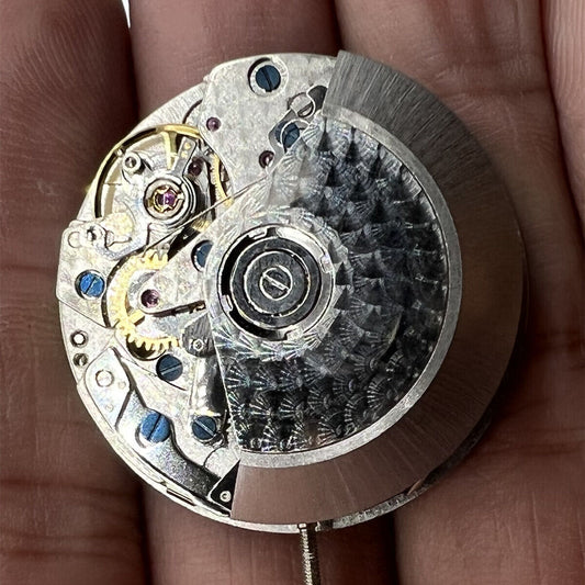 Black Dandong 7753 automatic watch with small second at 9, precision mechanical movement from China.