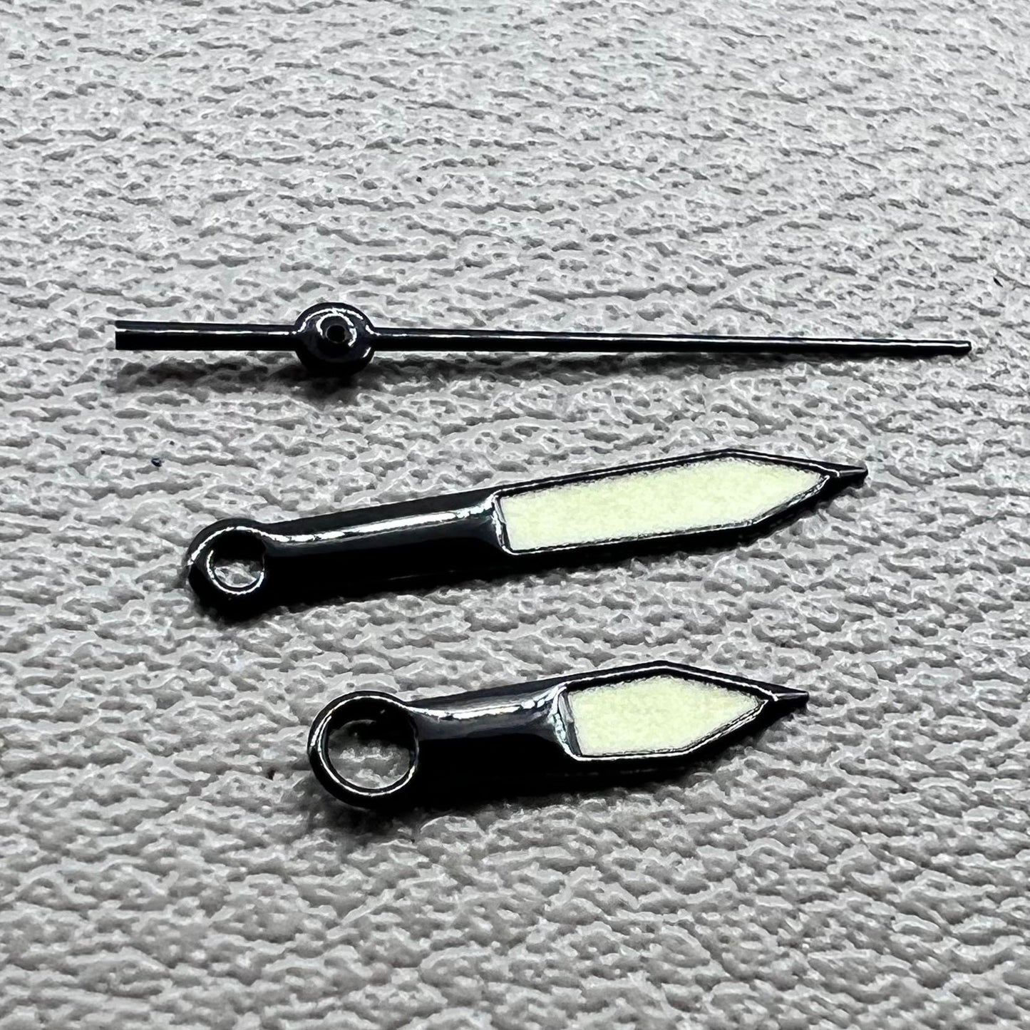 Black trim green lume watch hands set for Miyota 8215 with luminous tips, perfect for watch repairs and upgrades.