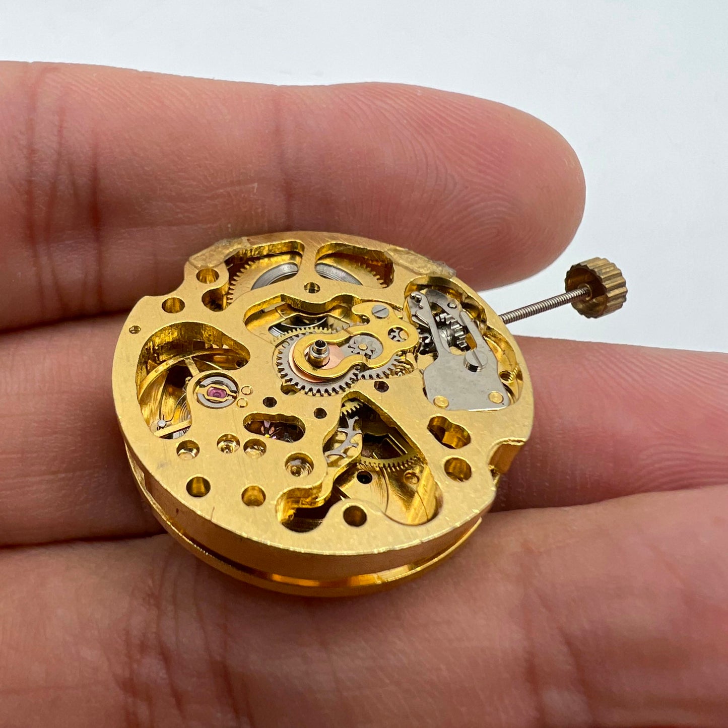 Golden hollow 26.5mm 7120 automatic mechanical watch movement, showcasing intricate gears and precision engineering.