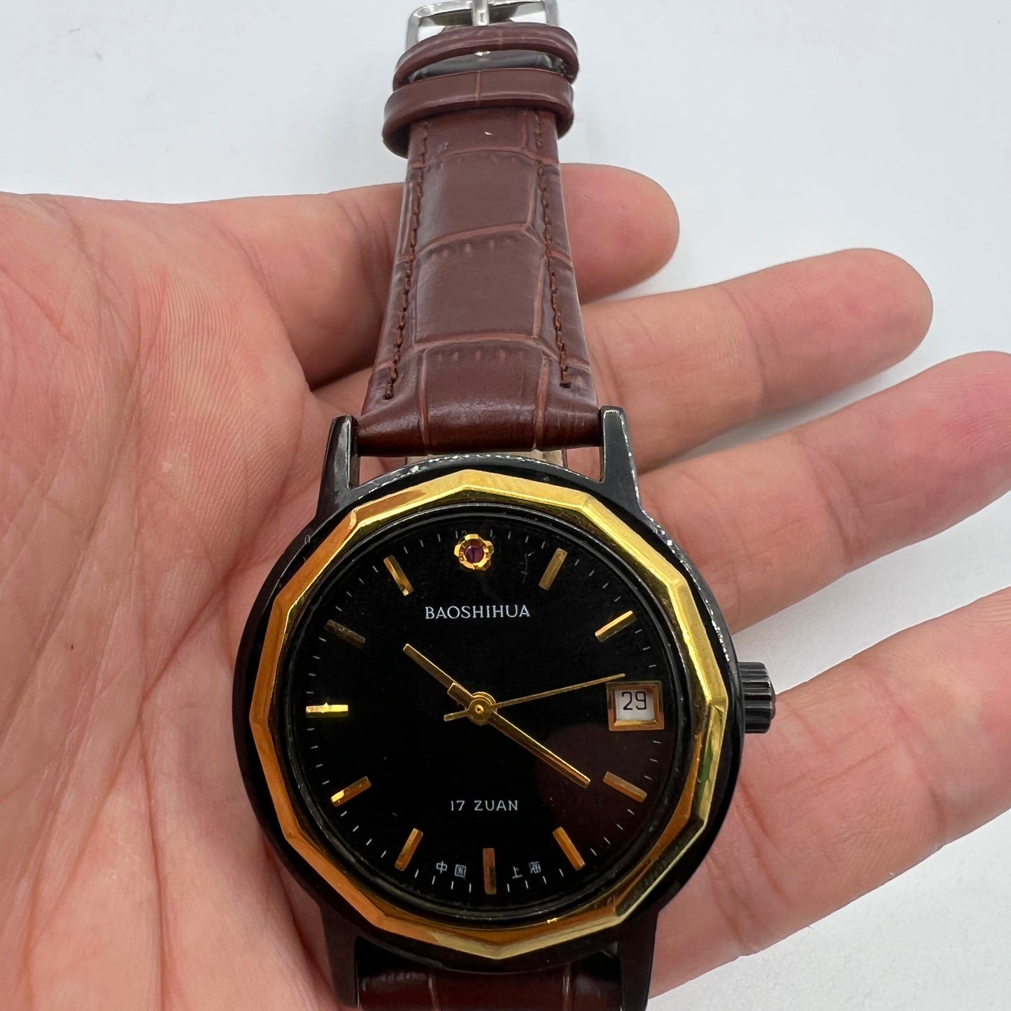 Classic 37mm Shanghai manual mechanical watch with black case and single calendar, showcasing timeless elegance.