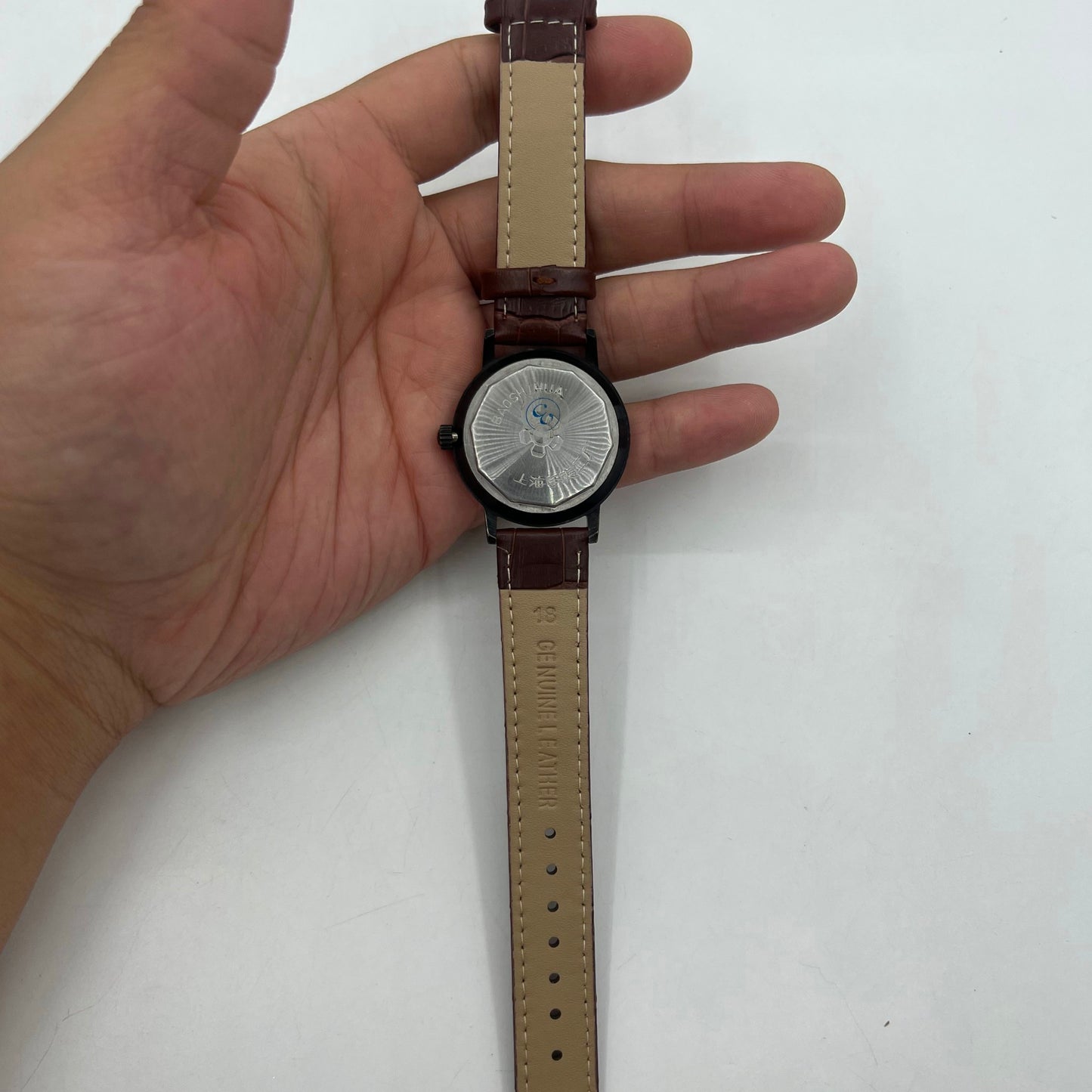 Classic 37mm Shanghai manual mechanical watch with single calendar, black case, showcasing timeless elegance.
