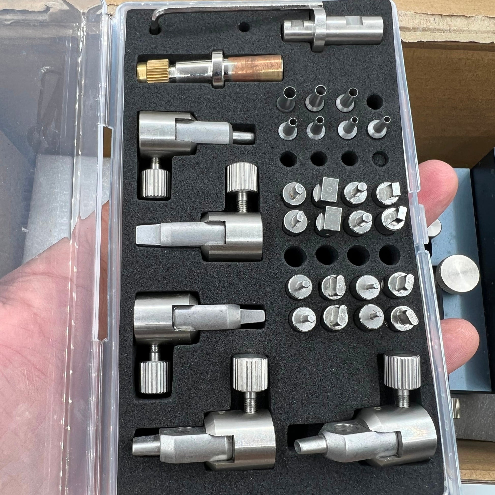 Watch strap hole punch set featuring multi-shape punches for precise strap adjustments and repairs.