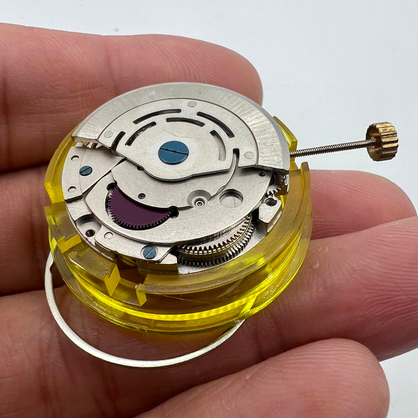 Silver China Made 2813 8205 automatic watch movement with single calendar display at 3 o'clock position, precision gear assembly by China Made.