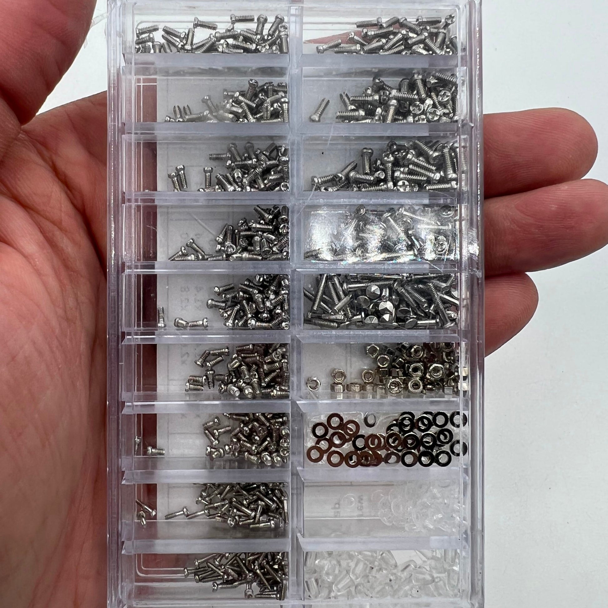 Assorted watch accessory screws and nuts set for precise micro repairs and adjustments.