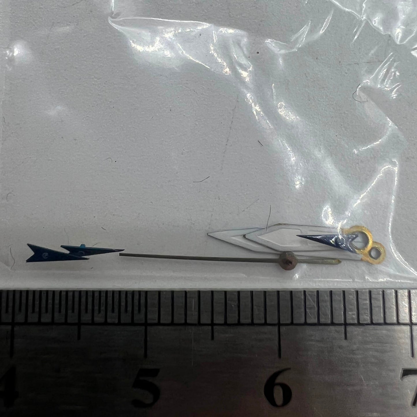 Dark blue arrow-shaped 13mm Miyota OS watch hands with precise trim, ideal for elegant timepieces.