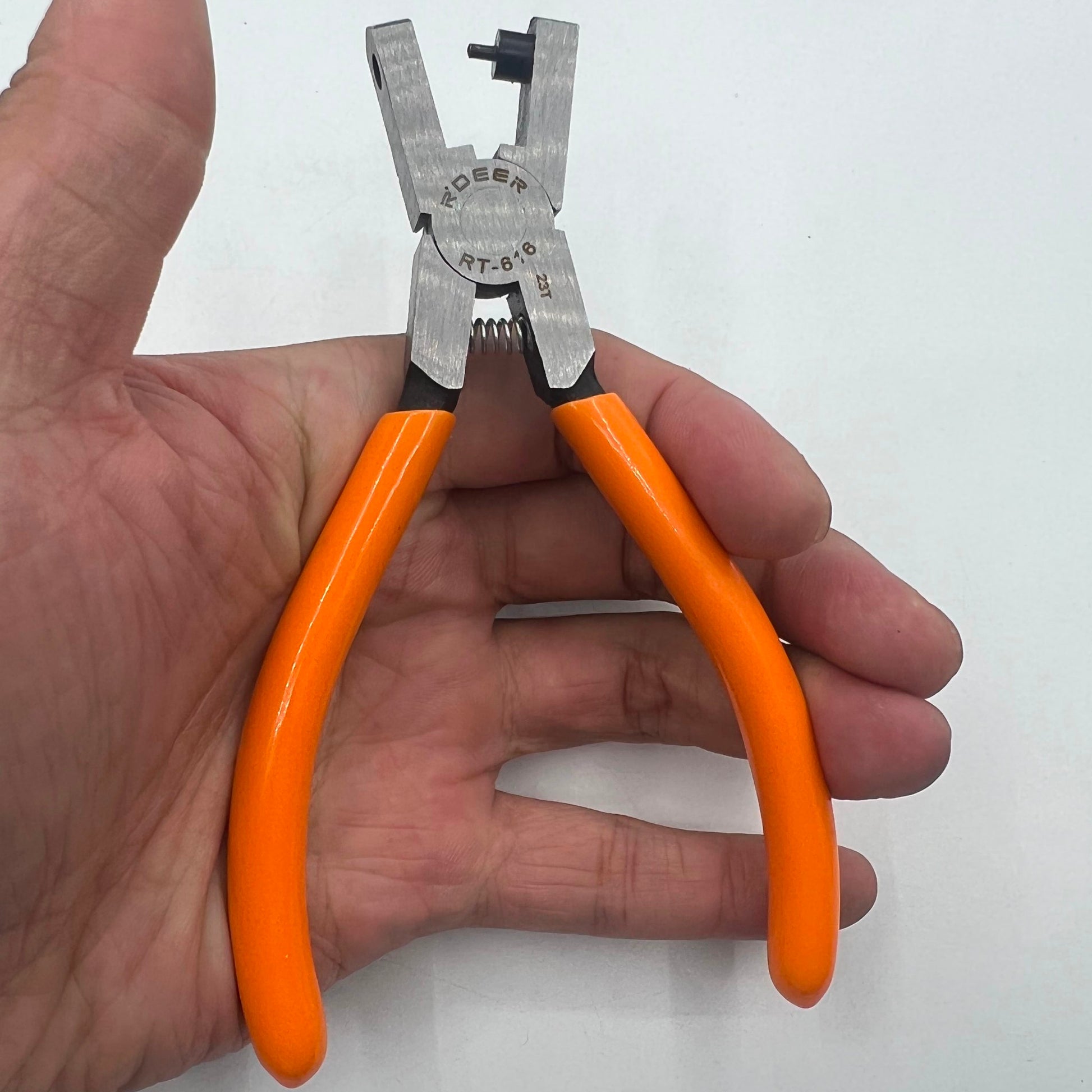 RT616 punch pliers tool creating precise 2mm holes for watch belt tag tape in watch repair.